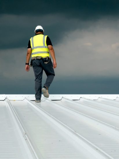 Construction engineer inspecting metal roofing work - Plumbing & Gasfitting Services in Dubbo, NSW