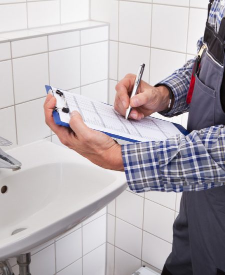 Close Up Of Plumber Standing In Front Of Wash Basin - Plumbing & Gasfitting Services in Dubbo, NSW