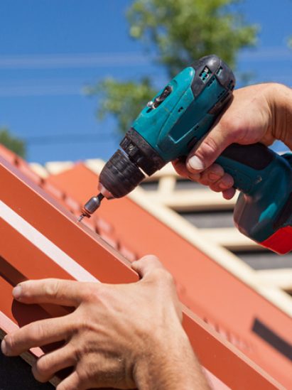 Installing Red Metal Roof Fascia - Plumbing & Gasfitting Services in Dubbo, NSW