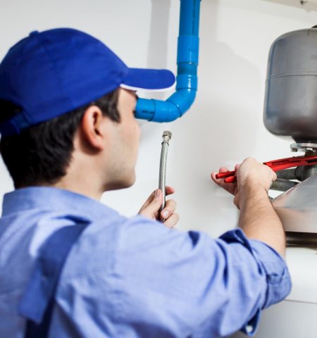 Plumber Looking at Hot Water System - Plumbing & Gasfitting Services in Dubbo, NSW